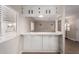 Bright kitchen pass through boasts white cabinets and countertop with natural light from the window at 2650 W Union Hills Dr # 350, Phoenix, AZ 85027