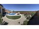 Wide shot of a desert backyard with a pool, hammock, patio furniture, and drought resistant plants at 26904 W Kerry Ln, Buckeye, AZ 85396
