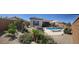Expansive backyard showcasing a pool, landscaped areas, and comfortable seating, creating an ideal retreat at 26904 W Kerry Ln, Buckeye, AZ 85396