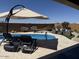 Relaxing backyard oasis with a sparkling pool, lounge chairs, hammock, and stylish outdoor seating area at 26904 W Kerry Ln, Buckeye, AZ 85396