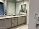 Bathroom showcasing granite countertops, double sinks, and decorative towel holders at 26904 W Kerry Ln, Buckeye, AZ 85396