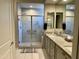 Bathroom featuring a glass-enclosed shower and a granite countertop double vanity at 26904 W Kerry Ln, Buckeye, AZ 85396