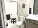 Bathroom featuring a tiled shower, a modern toilet, and a stylish vanity at 26904 W Kerry Ln, Buckeye, AZ 85396