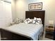 Cozy bedroom with starfish pillows, wood furniture, and chair near the closet at 26904 W Kerry Ln, Buckeye, AZ 85396
