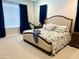 Bedroom with soft carpet and large window with dark blue curtains at 26904 W Kerry Ln, Buckeye, AZ 85396