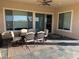 Covered patio with slate flooring, outdoor dining furniture, and ceiling fan for comfortable entertaining at 26904 W Kerry Ln, Buckeye, AZ 85396