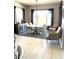 Dining room featuring a large window, a decorative rug, and elegant furnishings at 26904 W Kerry Ln, Buckeye, AZ 85396