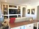 Bright living room with built in shelving surrounding a large television and electric fireplace at 26904 W Kerry Ln, Buckeye, AZ 85396