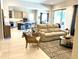 Open-concept living room with a view of kitchen, tile floors, and a comfortable seating area at 26904 W Kerry Ln, Buckeye, AZ 85396