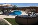 Inviting backyard pool and patio, perfect for relaxing and entertaining with stylish outdoor furniture and desert landscaping at 26904 W Kerry Ln, Buckeye, AZ 85396