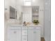 Bright bathroom with modern vanity, sleek mirror, quartz countertops, and tiled shower at 2765 S Cavalier Dr # 102, Gilbert, AZ 85295