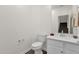 Neutral half bath with a pedestal sink and views of the stairs to the second floor at 2765 S Cavalier Dr # 102, Gilbert, AZ 85295