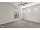 A simple bedroom with a large sliding window to access the balcony and an abundance of natural light at 2765 S Cavalier Dr # 102, Gilbert, AZ 85295