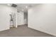 Well-lit bedroom with neutral carpet, white walls, and access to a bathroom at 2765 S Cavalier Dr # 102, Gilbert, AZ 85295