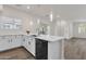 Open kitchen featuring white cabinetry, stainless steel appliances, and a kitchen island at 2765 S Cavalier Dr # 102, Gilbert, AZ 85295