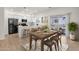 Bright, modern kitchen with white cabinets, stainless steel appliances, breakfast bar, and an adjoining outdoor patio at 2765 S Cavalier Dr # 102, Gilbert, AZ 85295