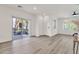 Bright, open-plan living area with sliding glass doors, wood-look floors, and modern ceiling fan at 2765 S Cavalier Dr # 102, Gilbert, AZ 85295