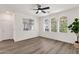 Bright living room featuring hardwood flooring, arched windows, and a ceiling fan at 2765 S Cavalier Dr # 102, Gilbert, AZ 85295