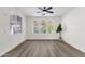 Bright living room featuring hardwood flooring, arched windows, and a ceiling fan at 2765 S Cavalier Dr # 102, Gilbert, AZ 85295