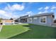 Backyard features a modern house exterior, lush green lawn, and a sparkling swimming pool at 2854 E Cashman Dr, Phoenix, AZ 85050