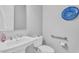 Bathroom features a pedestal sink, toilet with grab bar, and decorative blue plate on the wall at 2854 E Cashman Dr, Phoenix, AZ 85050
