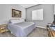 Cozy bedroom with carpet, a full bed, and a bright window with blinds at 2854 E Cashman Dr, Phoenix, AZ 85050