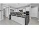 Well-appointed kitchen featuring a large island with dark countertops and stainless steel appliances at 2854 E Cashman Dr, Phoenix, AZ 85050