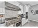 High-end kitchen featuring stainless steel range, modern backsplash, and designer fixtures at 2854 E Cashman Dr, Phoenix, AZ 85050