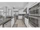 Gourmet kitchen showcasing stainless steel appliances, white cabinets, and tile backsplash at 2854 E Cashman Dr, Phoenix, AZ 85050