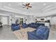Open-concept living room with neutral decor, ceiling fan, and seamless flow to kitchen at 2854 E Cashman Dr, Phoenix, AZ 85050