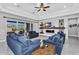 Spacious living room featuring a fireplace, ceiling fan, and access to an outdoor area at 2854 E Cashman Dr, Phoenix, AZ 85050