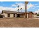 A home with desert landscaping and palm trees enhancing its curb appeal at 3037 W Libby St, Phoenix, AZ 85053