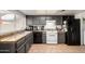 Well-lit kitchen features grey cabinetry, tile floors, and modern appliances at 3037 W Libby St, Phoenix, AZ 85053