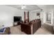 Cozy living room with plush carpet, ceiling fan, and large tv at 3037 W Libby St, Phoenix, AZ 85053