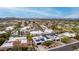 Wide aerial shot showcasing a neighborhood with a mix of houses, desert landscaping and mountain backdrop at 3258 E Vogel Ave, Phoenix, AZ 85028