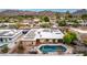 An inviting backyard pool and desert landscaping in a desert neighborhood against a mountain backdrop at 3258 E Vogel Ave, Phoenix, AZ 85028