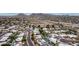 Expansive aerial view of a neighborhood with desert landscaping, houses and mountain views in the background at 3258 E Vogel Ave, Phoenix, AZ 85028