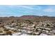 Aerial view with residential homes, desert landscaping and the majestic silhouette of a mountain range at 3258 E Vogel Ave, Phoenix, AZ 85028
