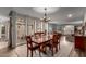 Inviting dining room features hardwood floors, a stylish chandelier, and sunlit views of the outdoor scenery at 3258 E Vogel Ave, Phoenix, AZ 85028
