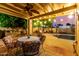 Outdoor patio with a covered dining area, a pool, and ambient string lights at 3258 E Vogel Ave, Phoenix, AZ 85028