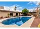 Sparkling backyard pool area with desert landscaping and beautiful desert flowers and lounge area at 3258 E Vogel Ave, Phoenix, AZ 85028