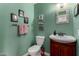 Charming powder room with decorative accents, framed art, and a cherry wood vanity, adding character to the home at 3258 E Vogel Ave, Phoenix, AZ 85028