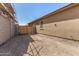Side yard featuring desert landscaping with gate and block fence at 33395 N 132Nd Dr, Peoria, AZ 85383