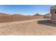 View of a spacious backyard with block wall fence and desert landscape at 33395 N 132Nd Dr, Peoria, AZ 85383