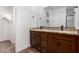 This bathroom features a granite countertop and dual sinks with dark wood cabinets at 33395 N 132Nd Dr, Peoria, AZ 85383