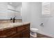 Bathroom featuring granite countertops, dark wood cabinetry, and updated fixtures at 33395 N 132Nd Dr, Peoria, AZ 85383
