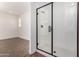 This bathroom has a glass-enclosed shower stall with a tile base, and a view into the bedroom at 33395 N 132Nd Dr, Peoria, AZ 85383
