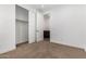 Bedroom with closet, neutral carpet, white walls, and a view into the bathroom at 33395 N 132Nd Dr, Peoria, AZ 85383