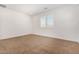 This bedroom is bright, has carpet, white walls and trim, and a window with plantation shutters at 33395 N 132Nd Dr, Peoria, AZ 85383