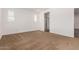 This spacious bedroom is bright, has carpet, white walls, and has a view into an adjoining bathroom at 33395 N 132Nd Dr, Peoria, AZ 85383